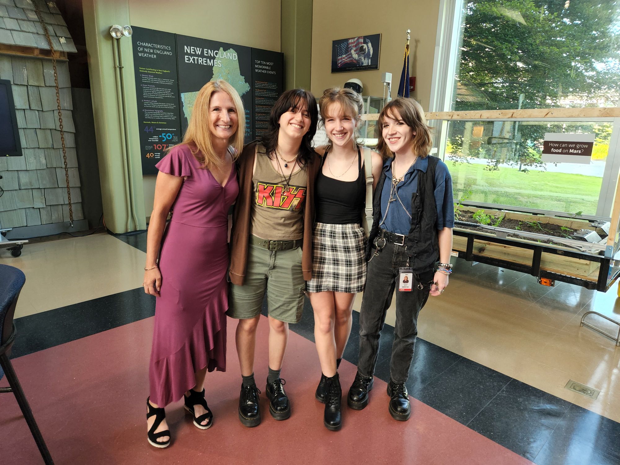 Mother Lorrie Miner, daughters Abbie and Sydney Miner and friend Hannah Parella pose by White Mountains Regional High School Farmbot-Growing Food