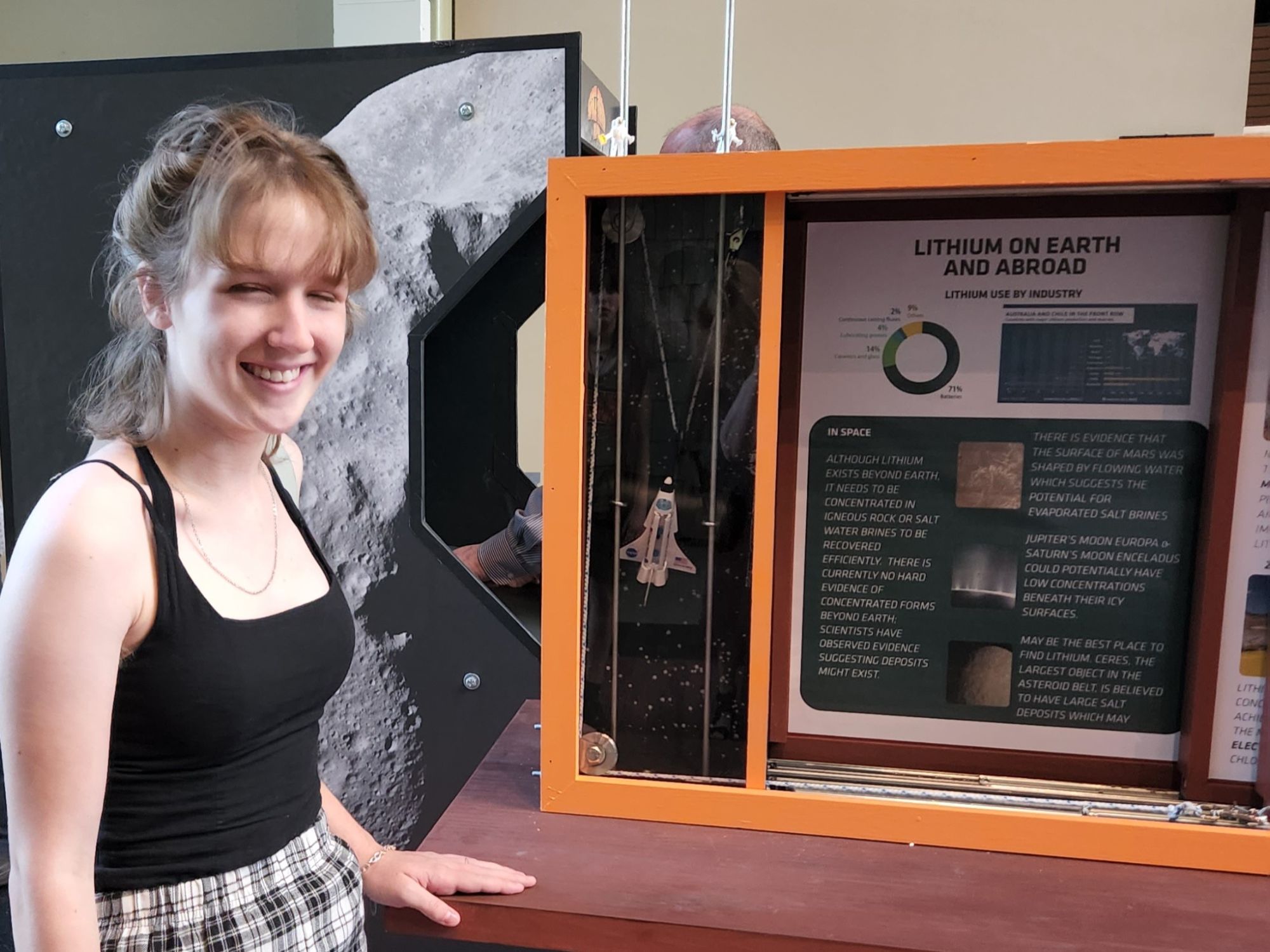 Seacoast School of Technology student Sylvia Miner by the Mining Lithium exhibit