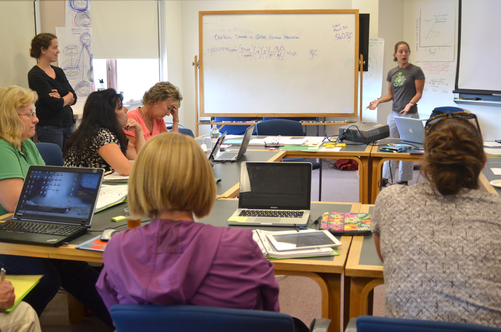 Two students are mentored by an adult volunteer from the National Society of Black Engineers
