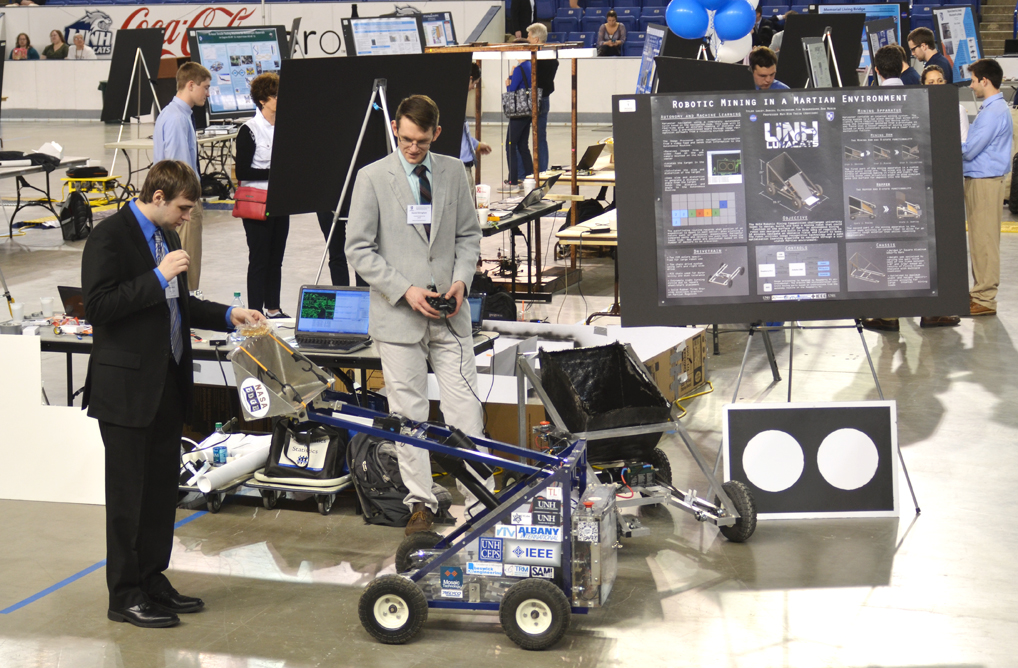 High school students from Project Smart work with an adult mentor on an electronics project