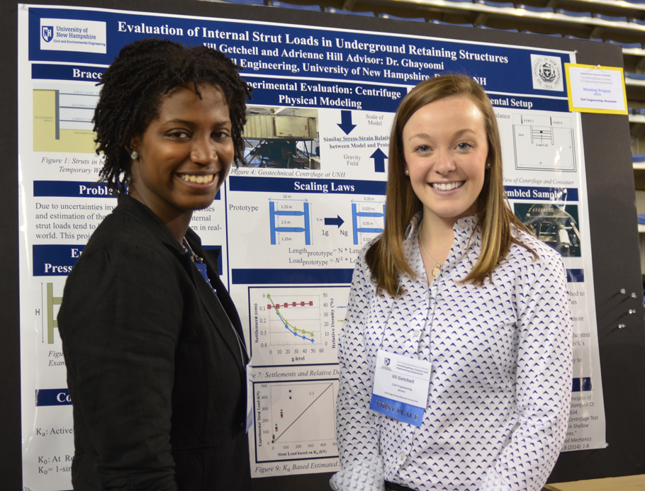 Two women stand in front of a research project poster at the Undergraduate Research Conference at UNH